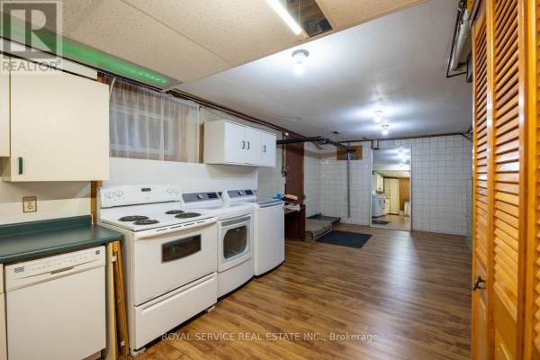 Basement kitchen with stove, dryer, dishwasher, and cabinets - 2311 Division Street N Hamilton Township