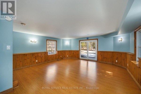 Finished basement with wood paneling, glass doors, and wood floors - 2311 Division Street N Hamilton Township