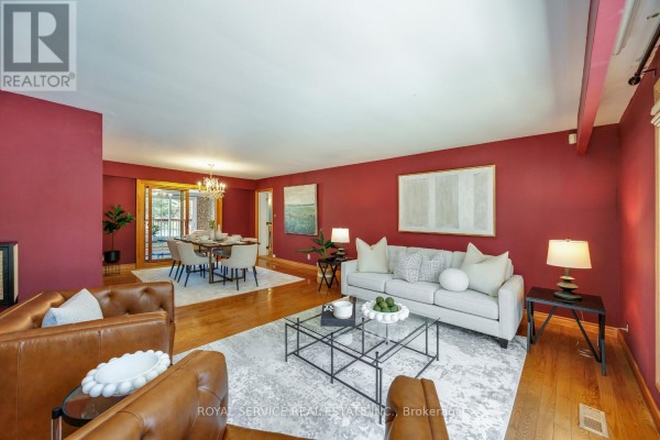 Living room with leather armchairs, sofa, glass coffee table, dining set and chandelier - 2311 Division Street N Hamilton Township