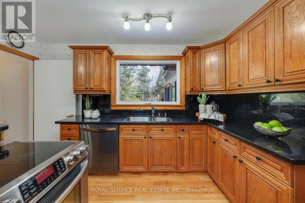 Oak cabinets, granite counters, double sink, stainless steel dishwasher, and window - 2311 Division Street N Hamilton Township