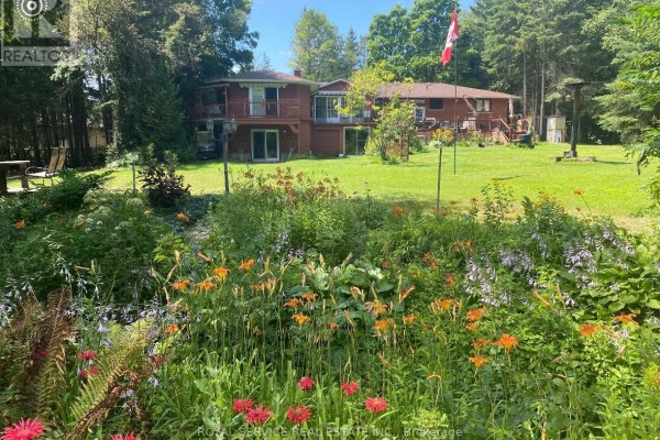 Two-story house with deck and flower garden - 2311 Division Street N Hamilton Township