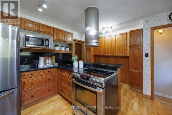 Kitchen with stainless steel appliances, granite countertops, and wooden cabinets - 2311 Division Street N Hamilton Township
