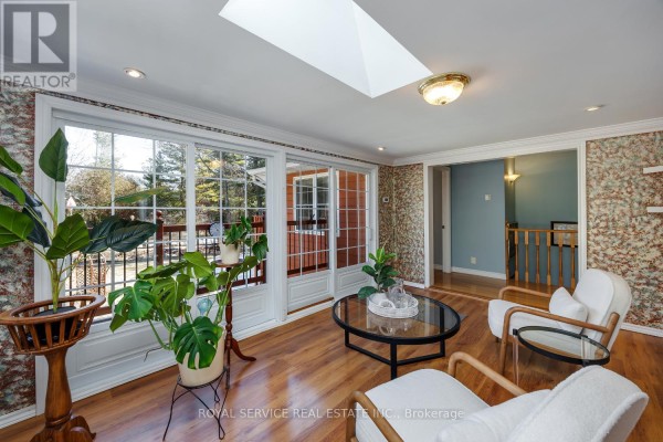 Sunroom with skylight, large windows, deck access, and seating - 2311 Division Street N Hamilton Township