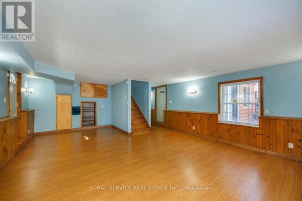 Room with wood paneled walls and staircase - 2311 Division Street N Hamilton Township
