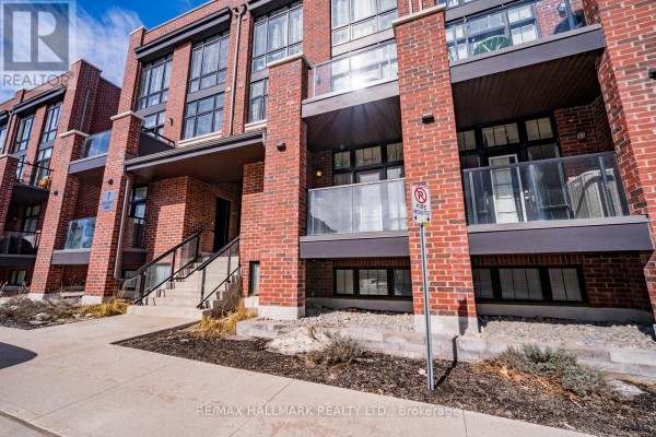 Exterior view of townhouse with red brick facade and balconies - 232 - 7 Bellcastle Gate, Whitchurch Stouffville