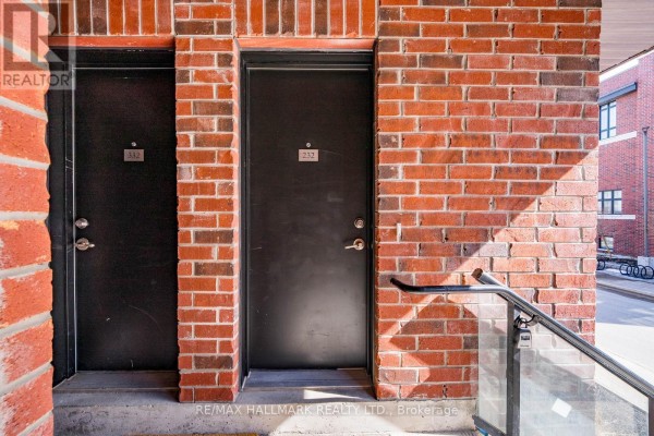 Close-up of two black doors with unit numbers in brick wall - 232 - 7 Bellcastle Gate, Whitchurch Stouffville