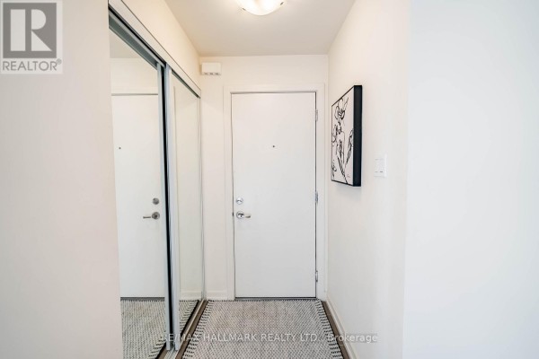 Entryway featuring mirrored closet doors and patterned tile flooring - 232 - 7 Bellcastle Gate, Whitchurch Stouffville