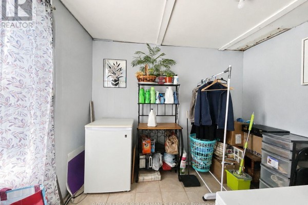 Laundry room with refrigerator, storage, and cleaning supplies - 232 Regent Street Hawkesbury