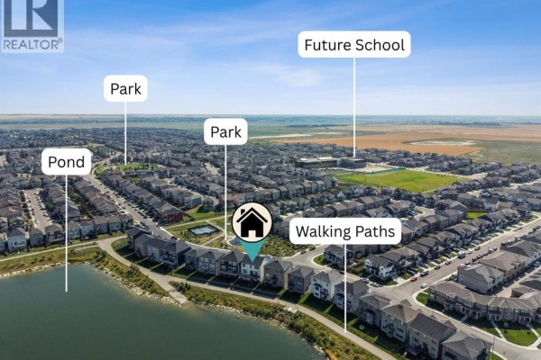 Aerial view of a neighborhood with amenities labeled, including parks, walking paths, and a future school. - 232 Windrow Link Sw, Airdrie