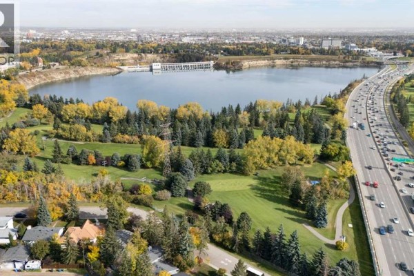 Aerial view of Weaselhead Flats park and the Glenmore Reservoir with a highway. - 2320 58 Avenue Sw, Calgary