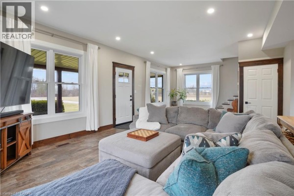 Living room with large sectional sofa and ottoman with chessboard - 23247 Beattie Drive Elgin