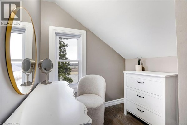Bedroom vanity with oval mirror, accent chair, and dresser - 23247 Beattie Drive Elgin