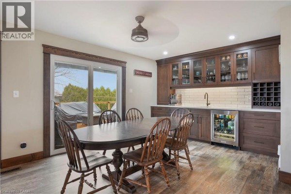 Dining room with table, chairs, wine rack, beverage cooler, and deck access - 23247 Beattie Drive Elgin