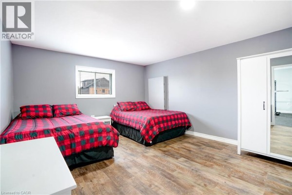 Bedroom with two plaid beds and wood floors - 23247 Beattie Drive Elgin