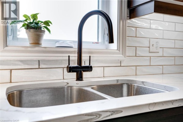 Double basin sink with gooseneck faucet and subway tile backsplash - 23247 Beattie Drive Elgin