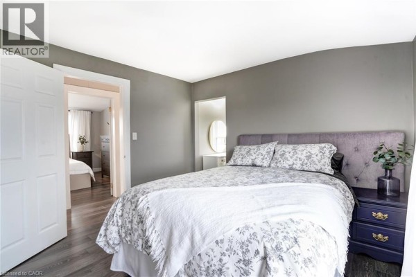 Bedroom with floral bedding and tufted headboard - 23247 Beattie Drive Elgin