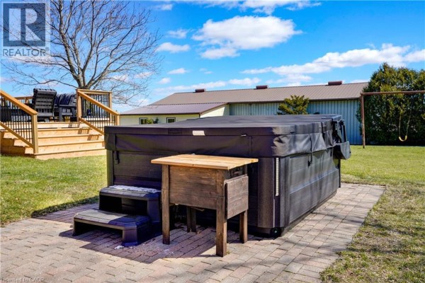 Hot tub, deck, and swing set in backyard - 23247 Beattie Drive Elgin