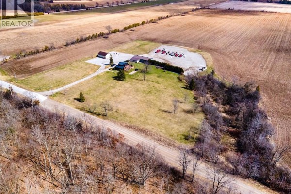 Aerial view of rural property with buildings and farm fields - 23247 Beattie Drive Elgin