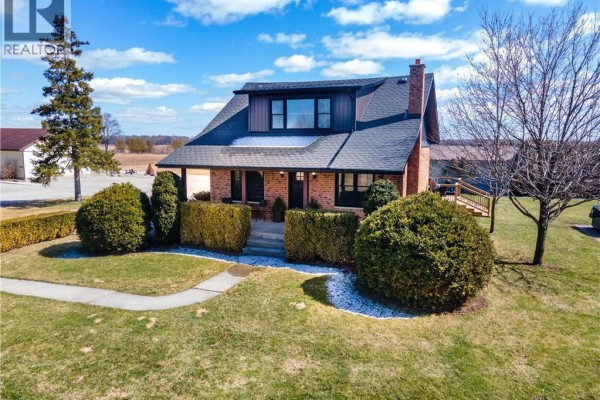 Brick house with gambrel roof and dormer window - 23247 Beattie Drive Elgin