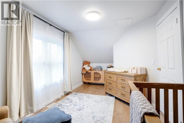 Nursery with crib, changing table, dresser, and rug - 23247 Beattie Drive Elgin