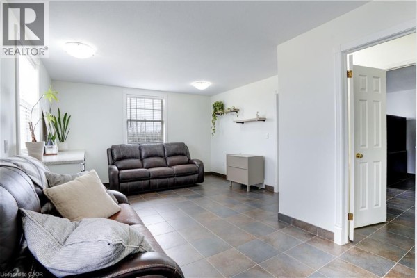 Leather sofas and tiled floor in living room - 23247 Beattie Drive Elgin