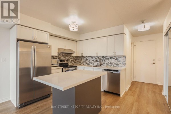 Open concept kitchen with stainless steel appliances, white cabinets, and a tiled backsplash. - 2328 - 3888 Duke Of York Boulevard, Mississauga