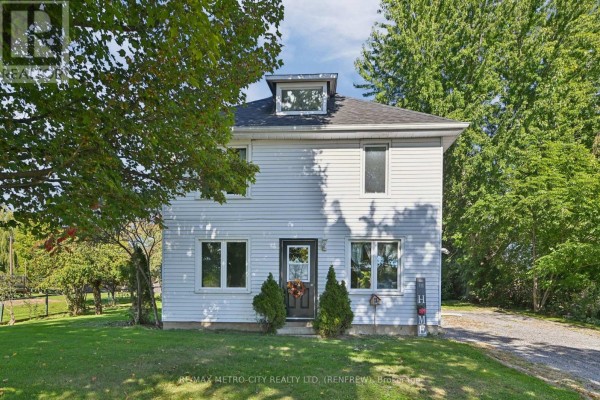 Front view of a white two-story house with a dark door and windows. - 2328 Kerr Line, Whitewater Region