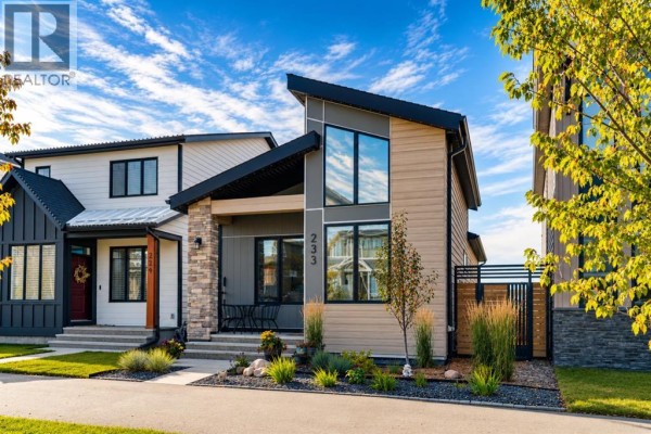 Side exterior view of the modern house, showing adjacent properties and landscaping. - 233 Haskayne Drive Nw, Calgary