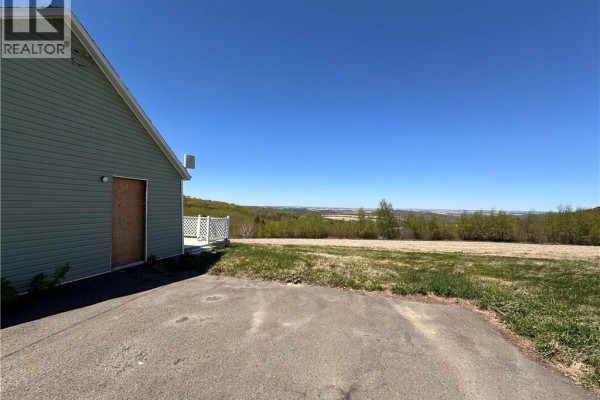 Cream-colored oil tank in a basement with concrete foundation and foam insulation. - 233 Hilldale Road, New Denmark