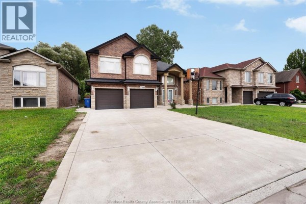 Aerial view of a brick house with a double garage and surrounding homes. - 2340 Rankin Avenue, Windsor