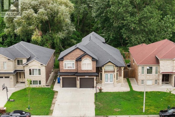 Kitchen with dark wood cabinets, granite countertops, and stainless steel appliances. - 2340 Rankin Avenue, Windsor