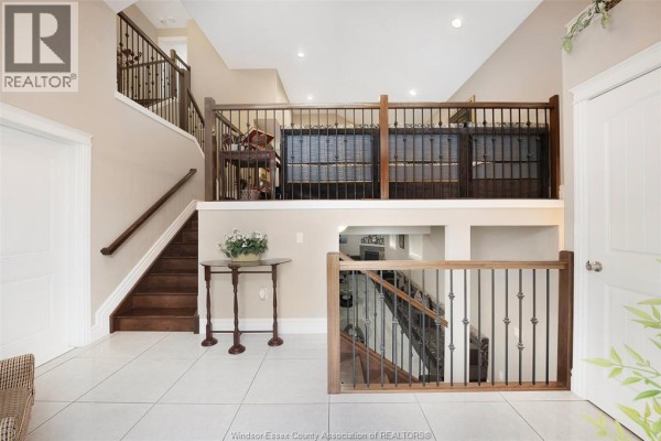 U-shaped kitchen with dark wood cabinets, granite countertops, and stainless steel stove. - 2340 Rankin Avenue, Windsor