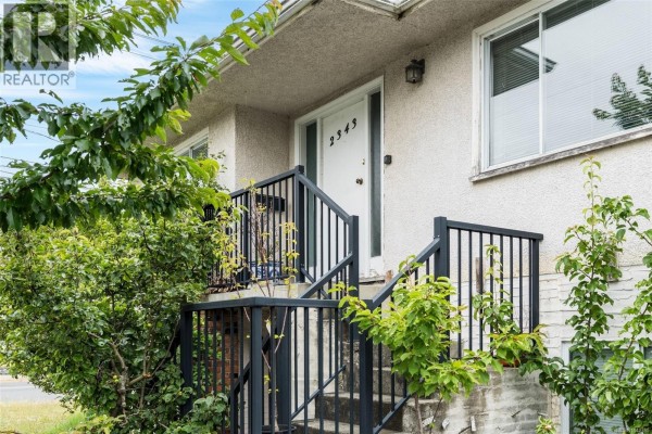Close-up of the front entrance with stairs, black railings, and the house number 2343. - 2343 Shelbourne St, Victoria
