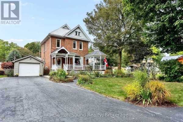 View of the front of the house with a driveway, garage, and gazebo. - 2344 3rd Avenue, Owen Sound