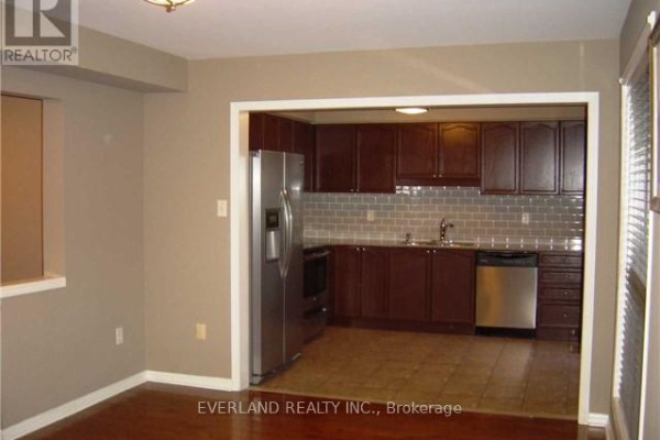 Kitchen with dark wood cabinets, grey subway tile backsplash, stainless steel appliances. - 2344 Proudfoot Trail, Oakville