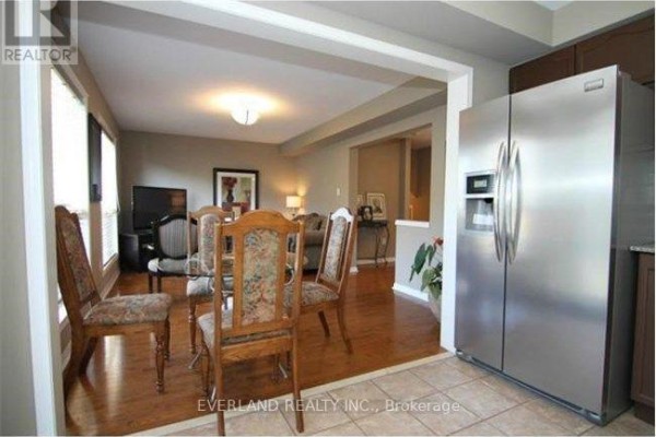 View from the kitchen to the dining and living areas with hardwood floors. - 2344 Proudfoot Trail, Oakville