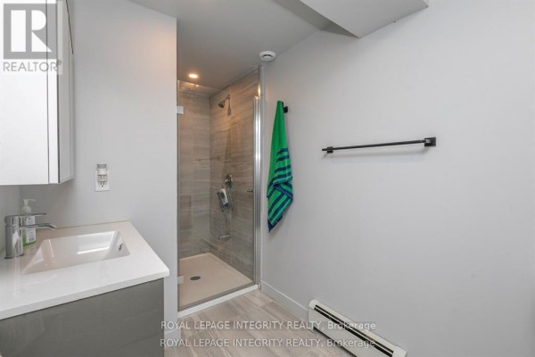 Close-up of the kitchen sink with black faucet and dark countertops. - 2347 Baseline Road, Ottawa