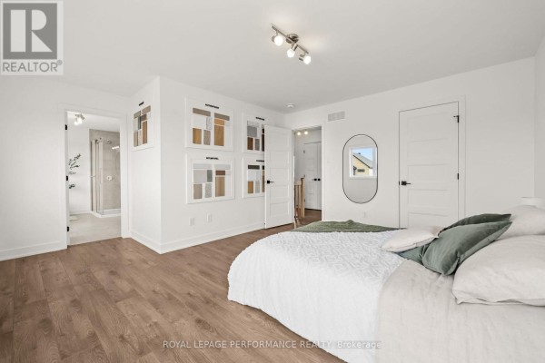 Bedroom with bed, oval mirror, artwork, and ensuite - 235 Bourdeau Boulevard The Nation