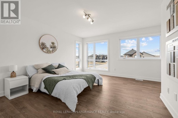 Bedroom with queen bed, side table, and large windows - 235 Bourdeau Boulevard The Nation