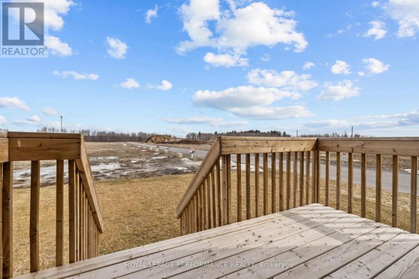 Wooden deck and stairs with rural view - 235 Bourdeau Boulevard The Nation