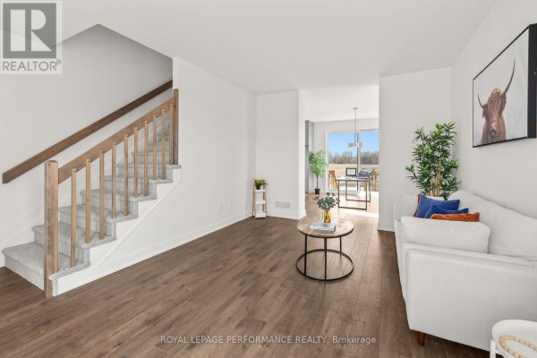 Living room with white sofa and wooden staircase - 235 Bourdeau Boulevard The Nation
