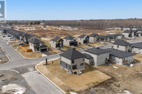 Modern houses on suburban street with forest background - 235 Bourdeau Boulevard The Nation