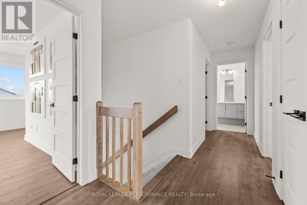 Hallway with wooden railings and wood flooring - 235 Bourdeau Boulevard The Nation