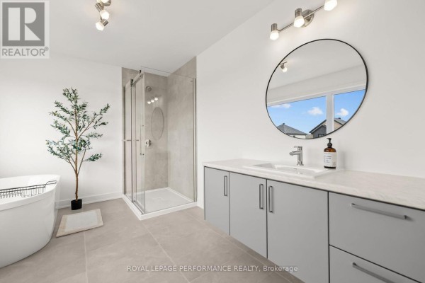 Freestanding tub, glass shower, double vanity & round mirror - 235 Bourdeau Boulevard The Nation