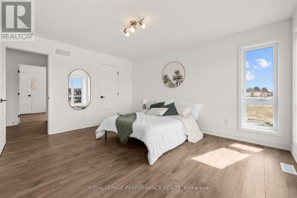 Bedroom with queen bed, mirror, and large window - 235 Bourdeau Boulevard The Nation