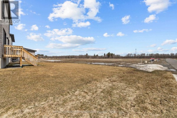 Undeveloped land with deck & 'for sale' signs - 235 Bourdeau Boulevard The Nation