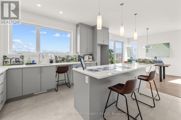 Modern kitchen with island, pendant lights, and community plans - 235 Bourdeau Boulevard The Nation