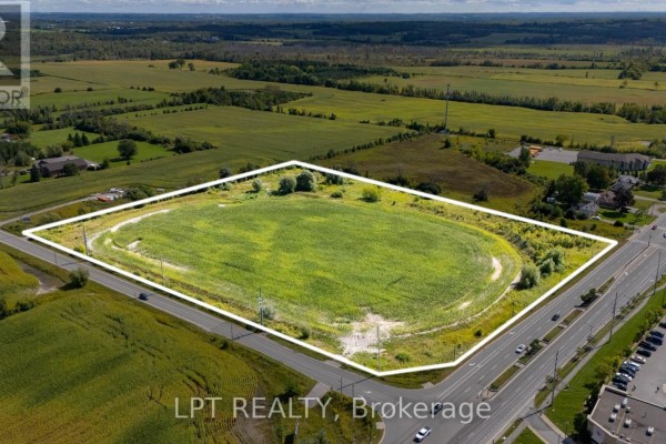 Overhead view of a large undeveloped land parcel bordered by roads and residential areas. - 2359 Glenwoods Avenue, Georgina