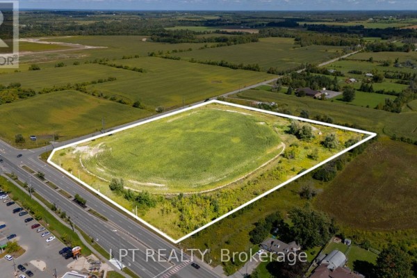 Aerial perspective of a vast, flat green field outlined with a white border, near suburban homes. - 2359 Glenwoods Avenue, Georgina