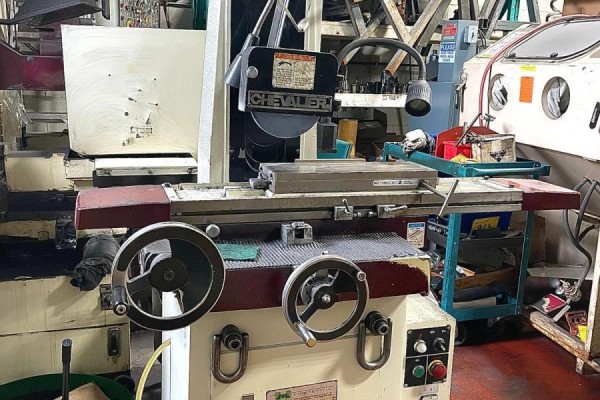 A metal grinding machine with two large manual adjustment wheels and a textured surface. - 236 Canarctic Drive, Toronto